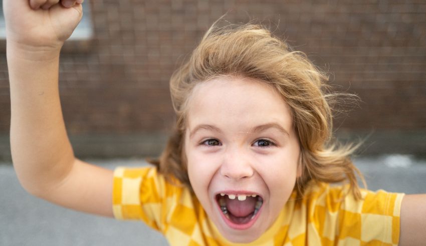 A young girl with her fist up in the air.