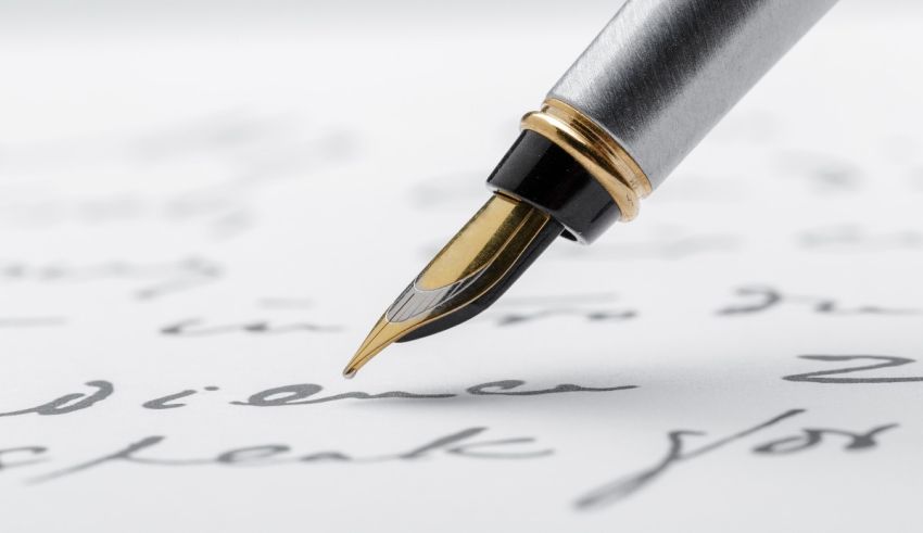 A fountain pen is writing on a piece of paper.
