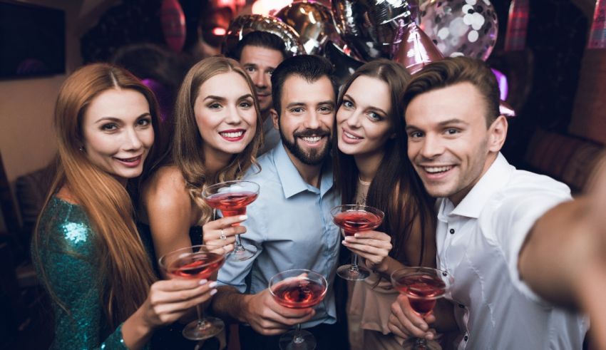 A group of friends taking a selfie at a party.