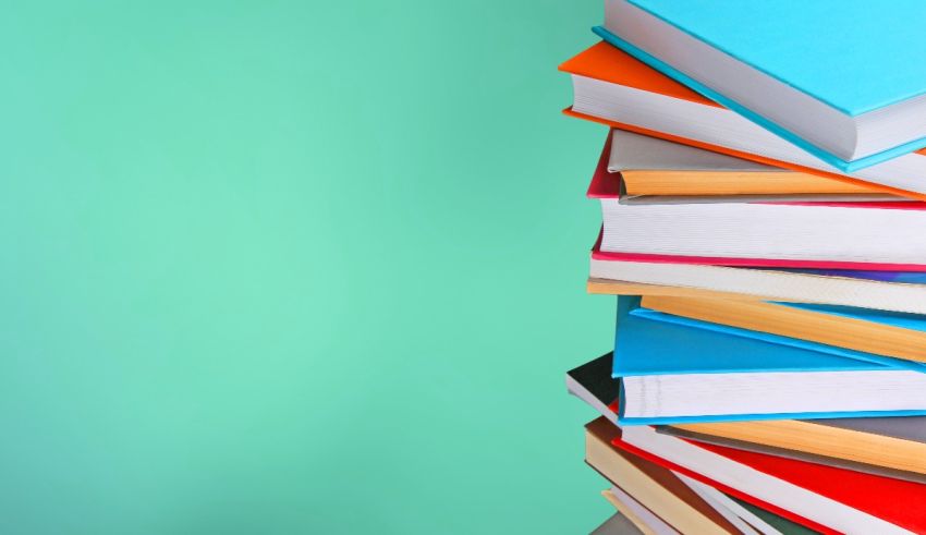 A stack of books on a green background.