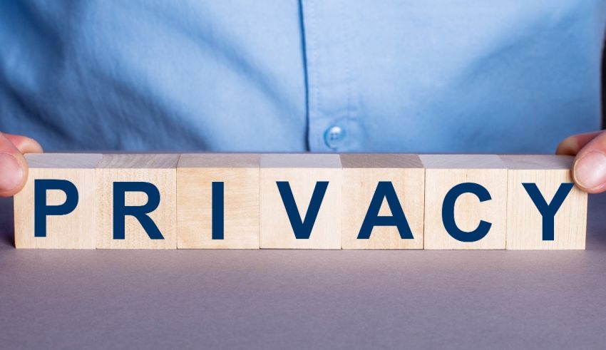 A man holding wooden blocks with the word privacy.