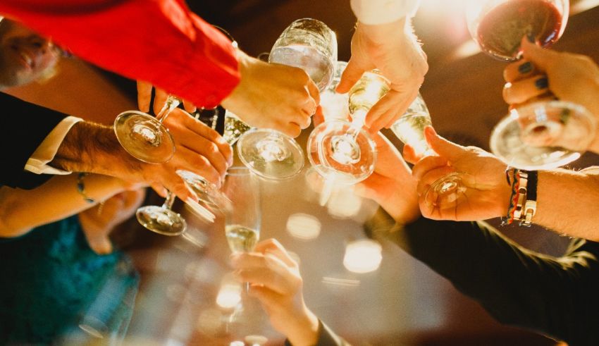 A group of people toasting wine glasses at a party.