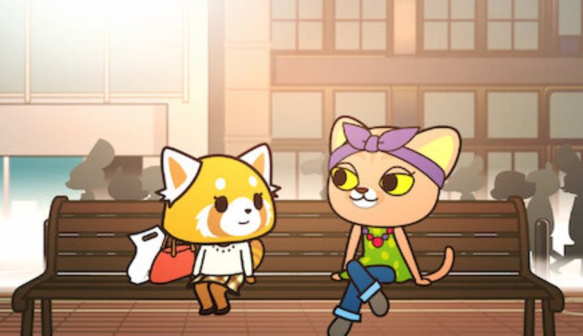 A cat and a cat sitting on a bench.