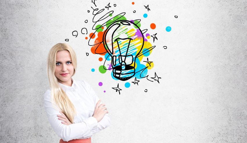 A young woman standing in front of a wall with a light bulb drawn on it.