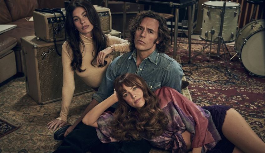 Three people laying on the floor in a living room.