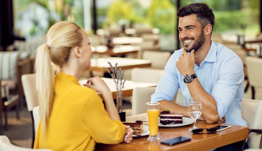A man and woman sitting at a table in a restaurant.