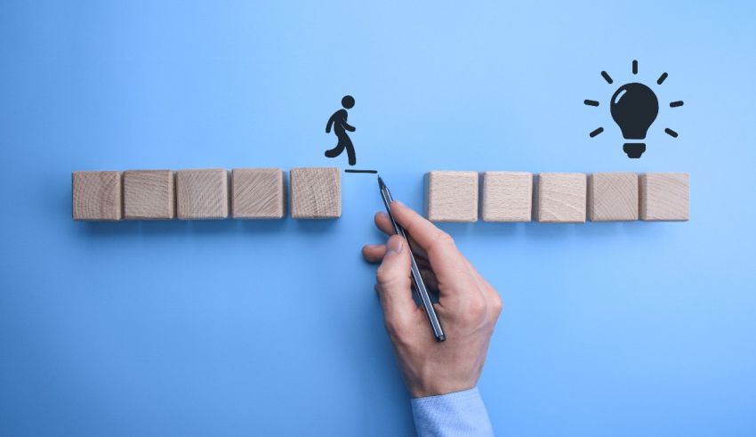 A person is standing on a wooden bridge with a light bulb on it.