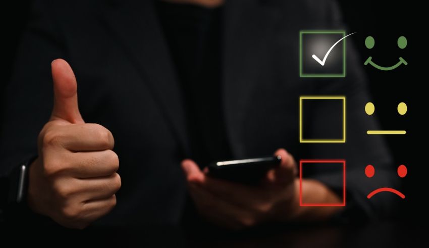 A businessman holding a cell phone with a thumbs up and a smiley face.