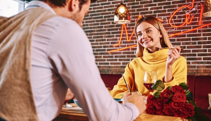 A man and woman sitting at a table in a restaurant.