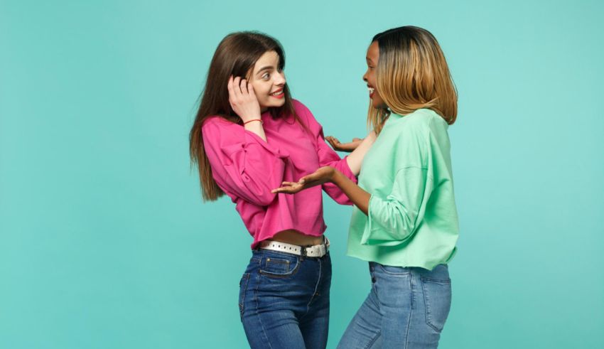 Two women are talking to each other on a blue background.
