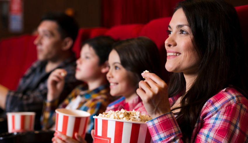 A family sitting in a theater watching a movie.