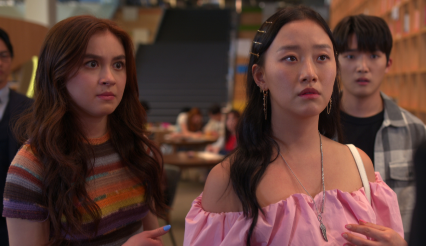 A group of asian people standing in a room.