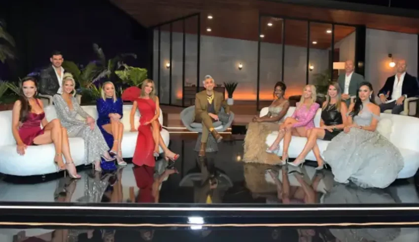 A group of people posing on a white couch.