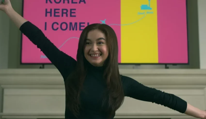 A woman with her arms outstretched in front of a tv.