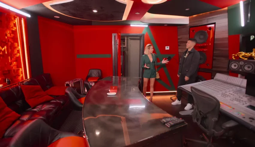 A man and woman standing in a recording studio.