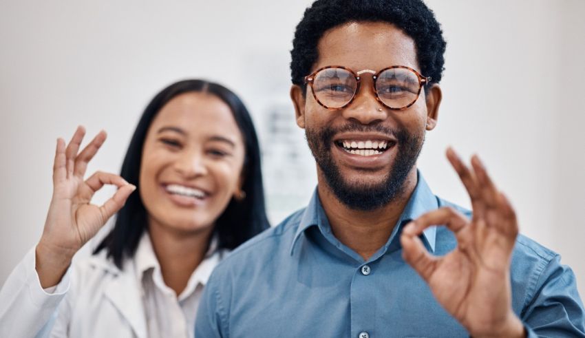 A man and a woman showing the ok sign.