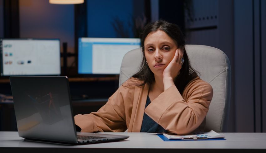 A woman sitting in front of a computer at night.