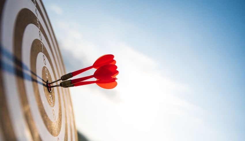 Two red darts in the center of a target.
