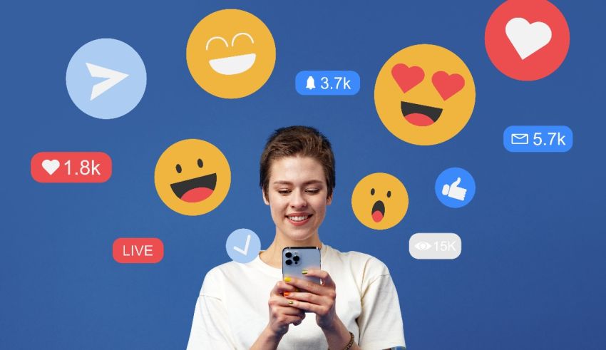 A woman holding a cell phone with emojis flying around her.