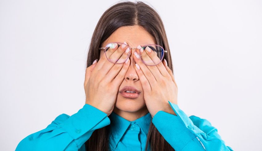 A young woman covering her eyes with her hands.