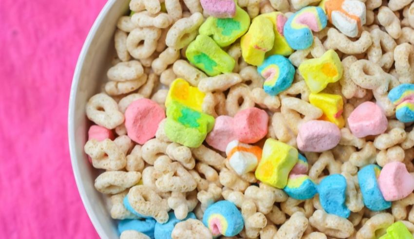 St patrick's day cereal in a bowl on a pink background.