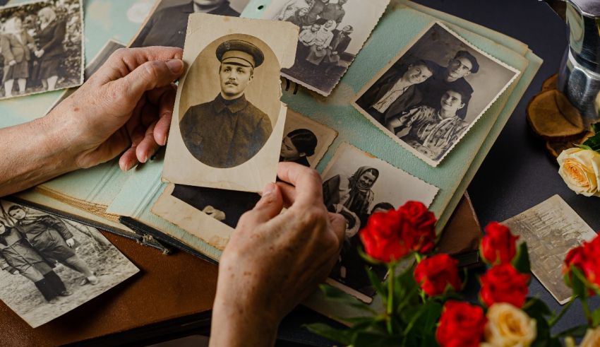 A woman is holding a book of old photos.