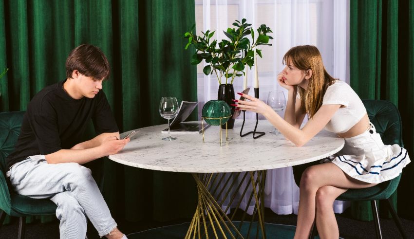 A man and woman sitting at a table in a restaurant.