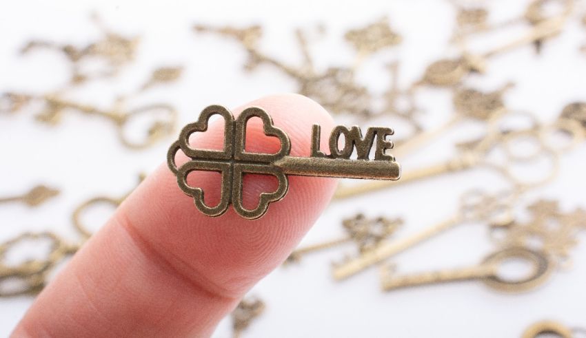 A person holding a key with the word love on it.