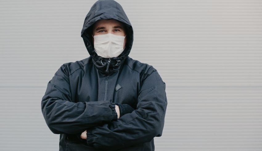 A man wearing a protective mask and jacket.