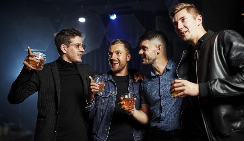 A group of men drinking beer at a nightclub.