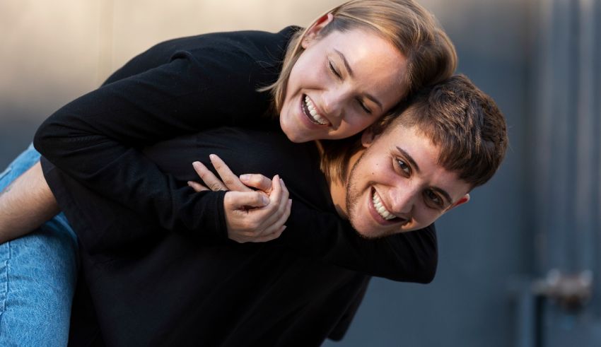 A young man is piggybacking a young woman.