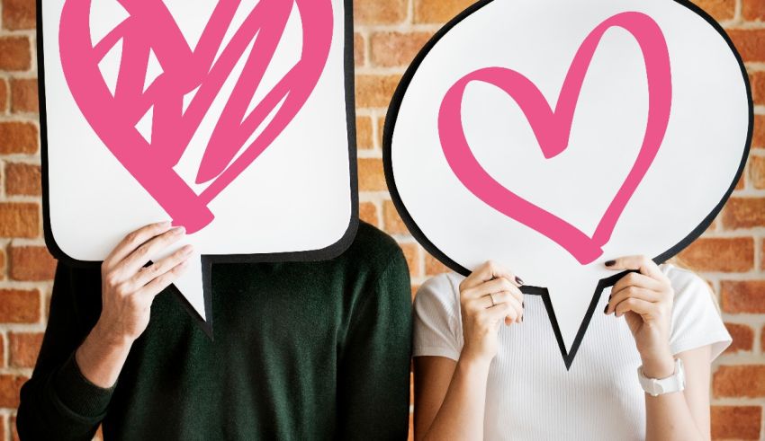 Two people holding speech bubbles with hearts on them.