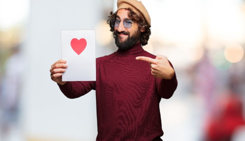 A man holding up a card with a heart on it.