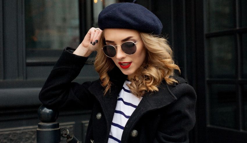 A woman wearing sunglasses and a beret.