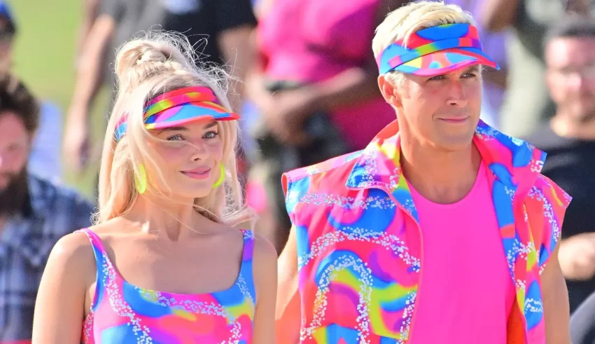 A man and a woman dressed in bright colors and hats.