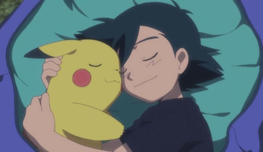 A boy is hugging a stuffed pikachu.