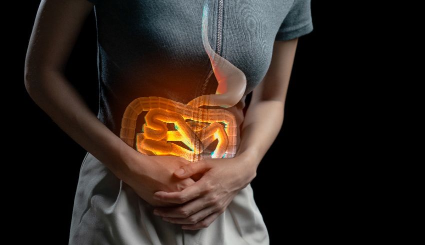 A woman holding her stomach with an illuminated stomach.