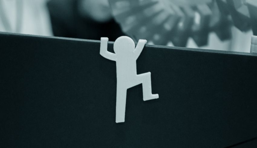 A black and white photo of a person standing on a desk.