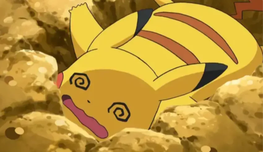 A pikachu is laying in a pile of dirt.