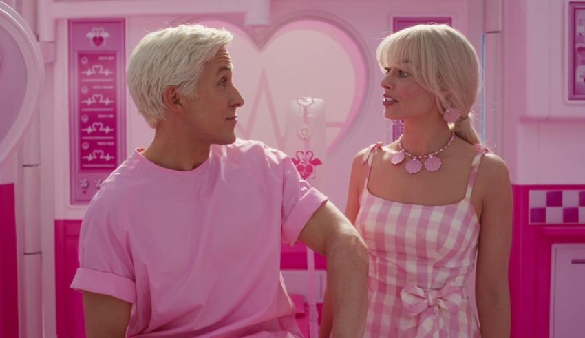 A man and a woman standing in a pink room.