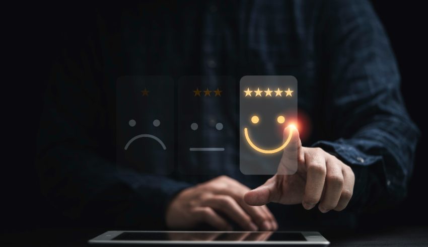 A man is pointing at a tablet with a smiley face on it.
