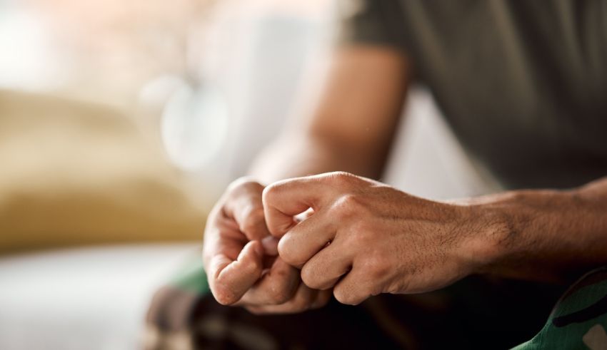 A man's hands holding a piece of paper.