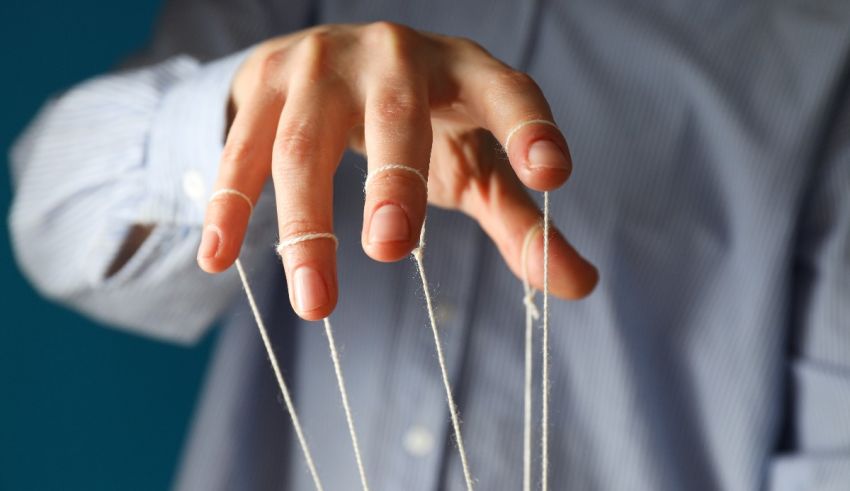 A man's hand holding a string of strings.