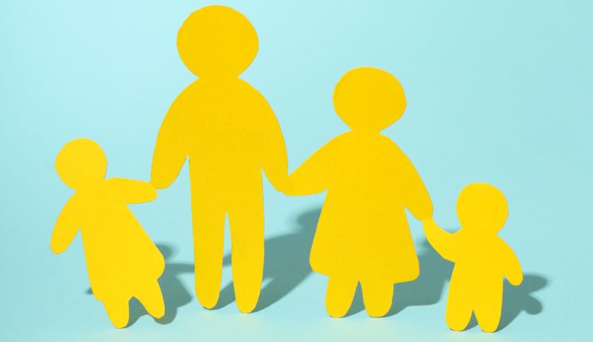 Yellow paper cut outs of a family holding hands on a blue background.