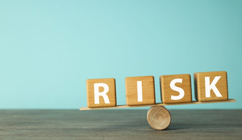 A wooden block with the word risk stacked on top of it.
