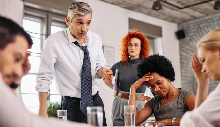 A group of people sitting around a table in a meeting.