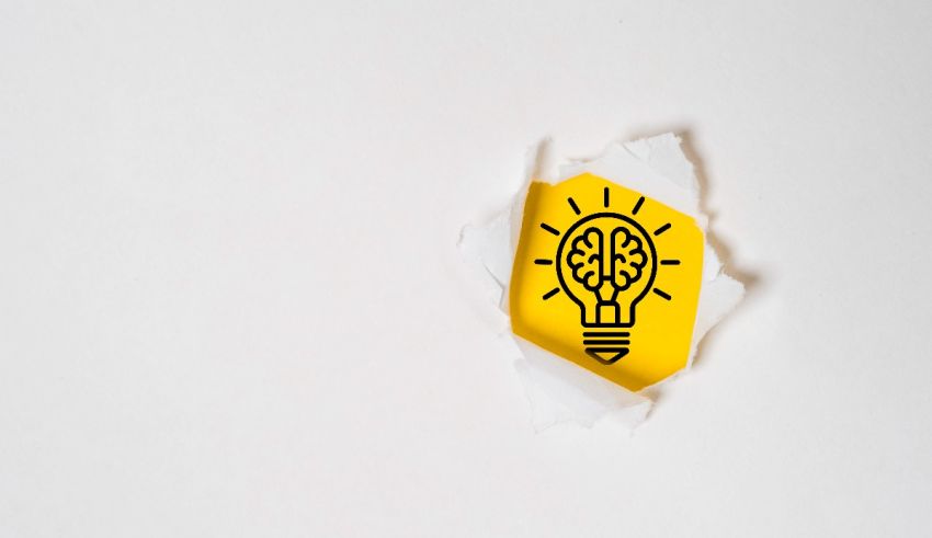 A yellow light bulb on a piece of paper.