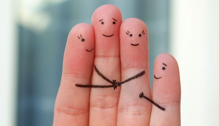 A person's fingers are drawn with a smiley face on them.