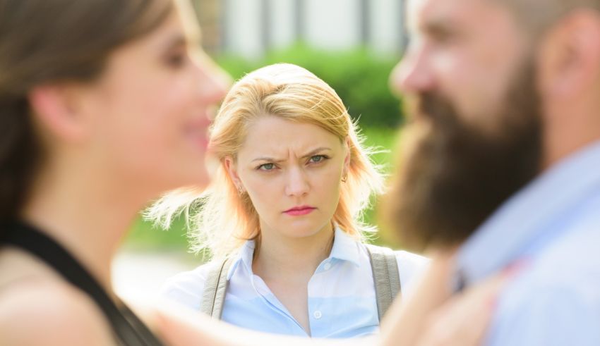 A woman is looking at a man with a beard.