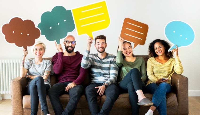 A group of people sitting on a couch with speech bubbles.